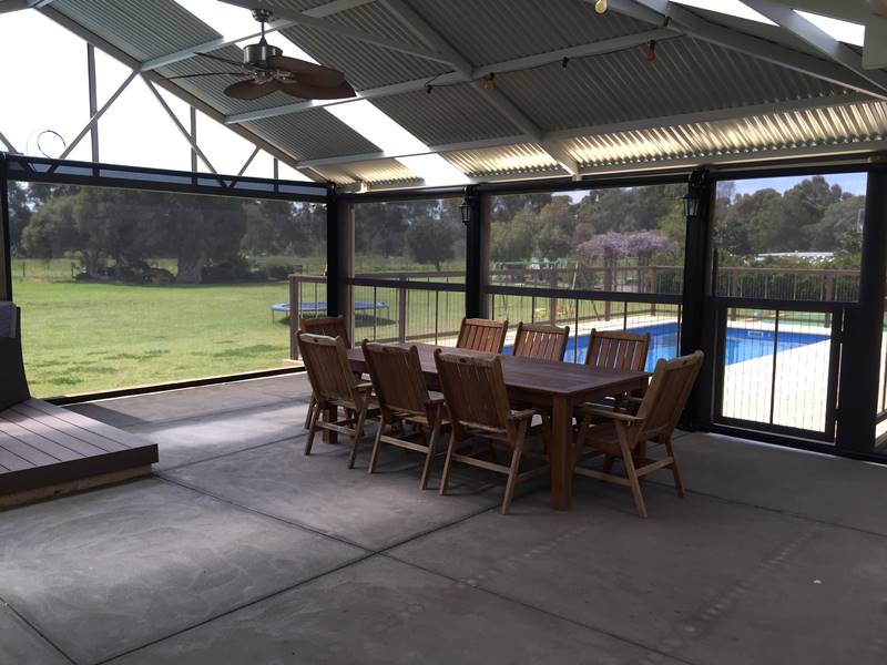 8 person dining table in alfresco area with patio blinds